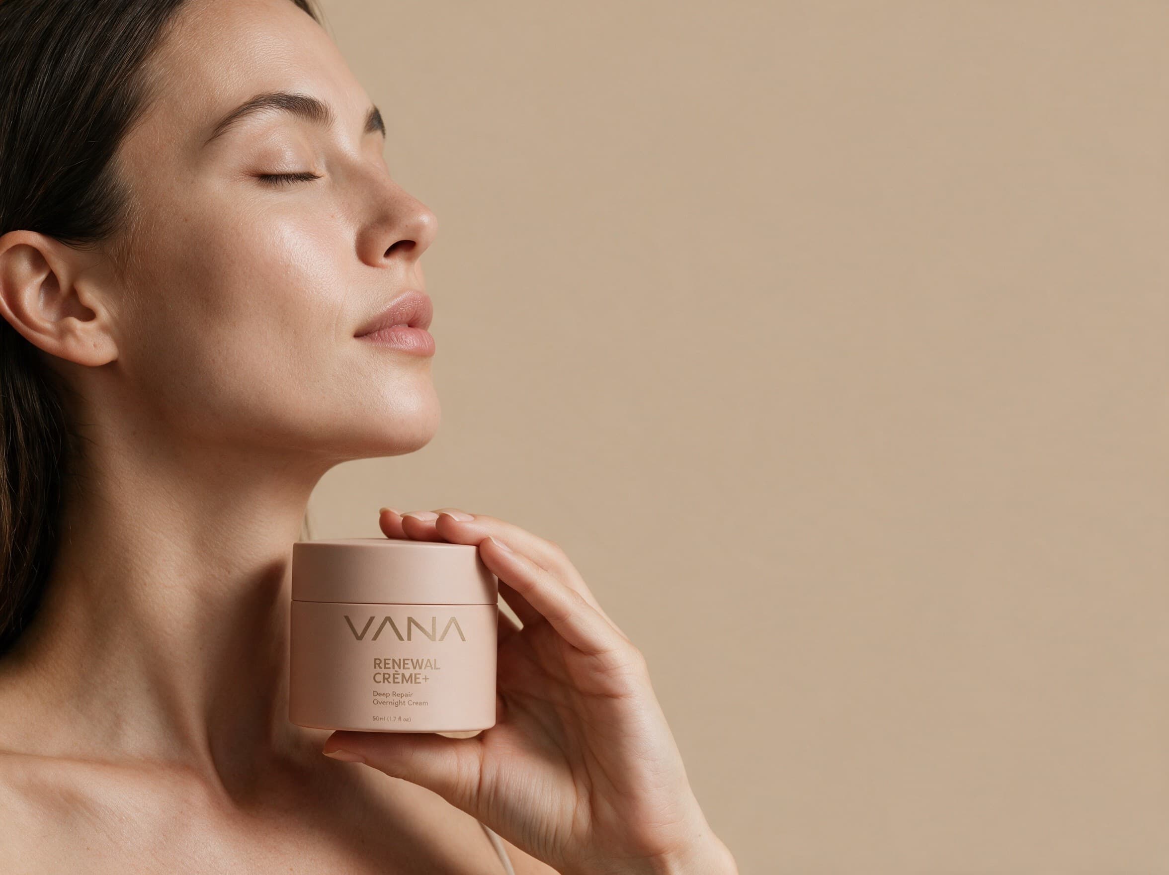 Woman holding the VANA Renewal Crème+ jar against a warm beige backdrop